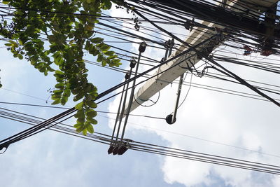 Low angle view of electricity pylon against sky