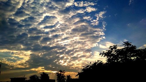 Low angle view of silhouette trees against sky during sunset