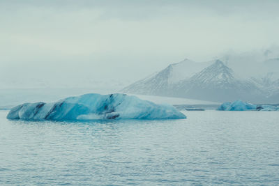 Striped iceberg floating in sea landscape photo