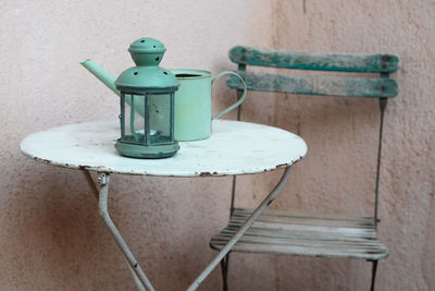 Close-up of kettle with lamp on table