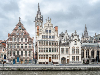 Buildings against cloudy sky