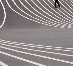 Low section of person walking on road