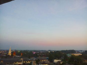 High angle view of buildings in city at sunset