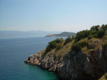 Scenic view of sea with mountain range in background