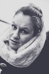 Close-up portrait of smiling young woman looking away