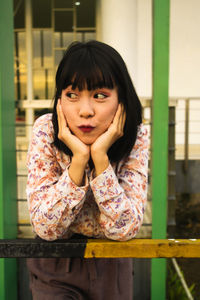 Portrait of teenage girl sitting outdoors