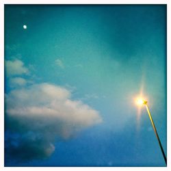 Low angle view of street light against blue sky