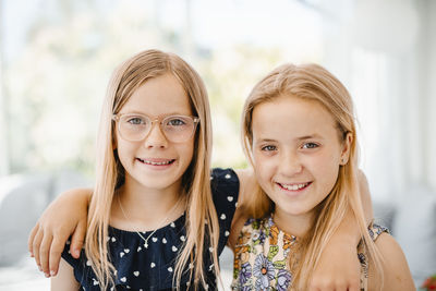 Portrait of smiling sisters looking at camera