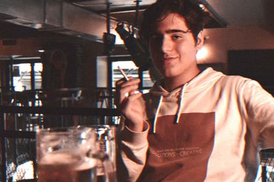 Portrait of a young man drinking glass