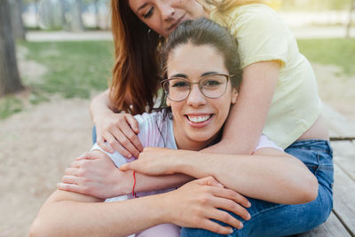 Side view of young woman sitting outdoors