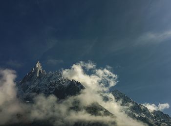 Low angle view of snowcapped mountain against sky