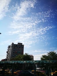 Low angle view of building against cloudy sky