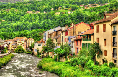 Houses in village amidst buildings in town