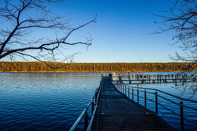 Pier over lake against sky