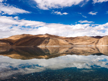 Scenic view of lake against cloudy sky