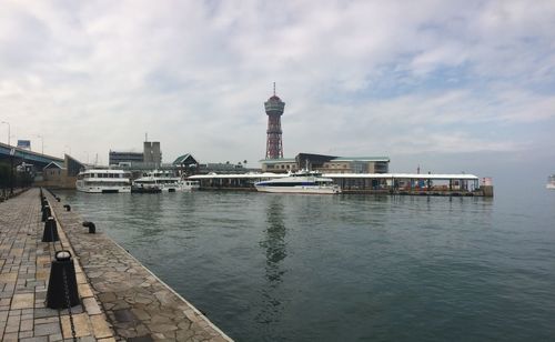 Buildings by sea against sky in city