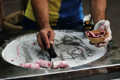 Midsection of man preparing food