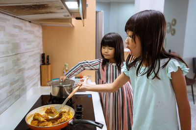 Women standing in kitchen at home
