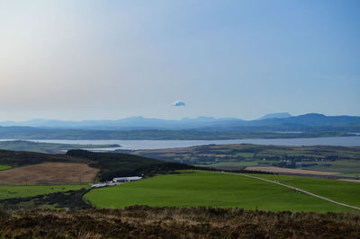 Scenic view of farm against sky