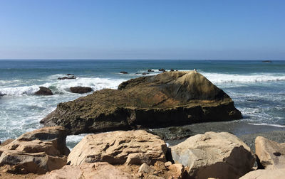 Scenic view of sea against clear blue sky