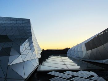 Modern city against clear sky during sunset