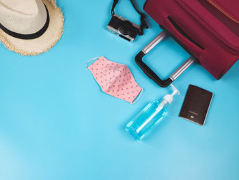 High angle view of hat on table against blue background