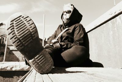 Full length of man sitting outdoors