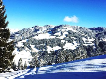 Scenic view of snow covered mountains against sky