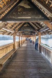 People on pier amidst bridge