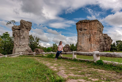 Woman looking at old ruins against sky