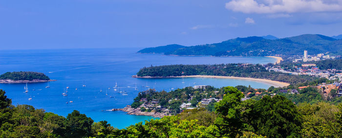 High angle view of sea and cityscape against sky