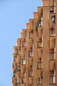 Low angle view of modern building against clear blue sky