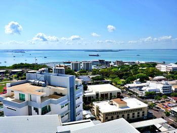 High angle view of buildings and sea against sky