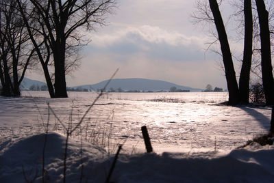 Scenic view of frozen lake against sky during winter