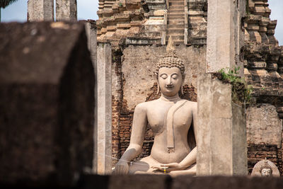 Statue of buddha against building