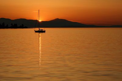 Scenic view of sea against orange sky