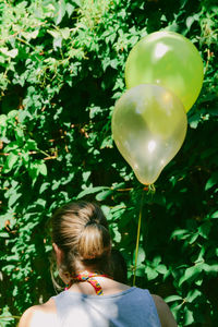 Rear view of woman with balloons