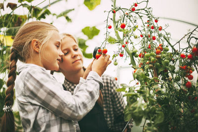 Mother and daughter against plants