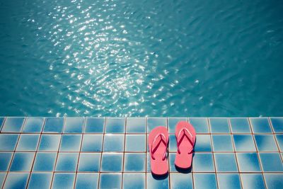 High angle view of slipper by swimming pool