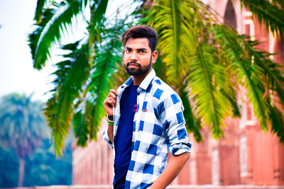 Portrait of young man standing outdoors