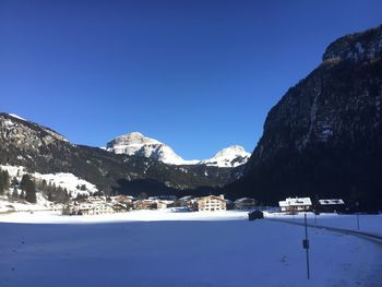 Scenic view of snowcapped mountains against clear blue sky