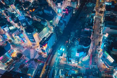 High angle view of illuminated city street and buildings at night