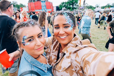 Portrait of smiling young friends during music festival