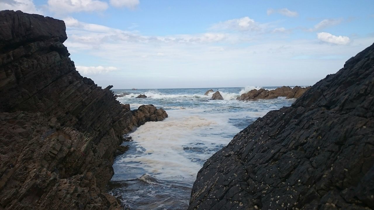 sea, water, horizon over water, scenics, sky, tranquil scene, beauty in nature, tranquility, rock formation, rock - object, beach, nature, shore, wave, idyllic, cliff, rock, coastline, surf, cloud - sky