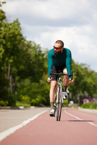 Man riding bicycle on road