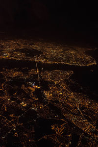 Full frame shot of illuminated cityscape against sky at night
