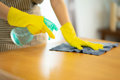 Cropped hand of person cleaning floor