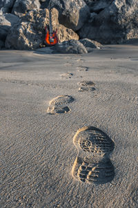 High angle view of footprints on rock at beach