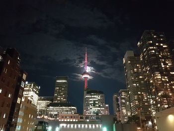 Low angle view of skyscrapers lit up at night