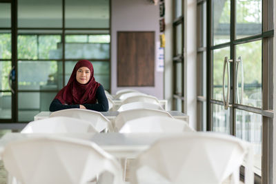 Portrait of woman sitting at table in restaurant